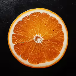 the blood orange cut in half has water droplets on it