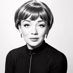 a woman with short hair wearing a black shirt