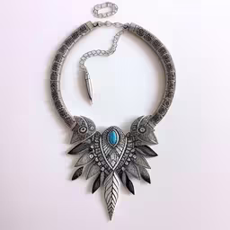 a collar with chains and an arrow is shown on a white background,a necklace is displayed with a white background