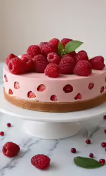 a cake with lots of raspberries on top