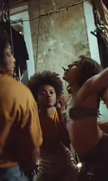 four women are in a dance studio on the phone