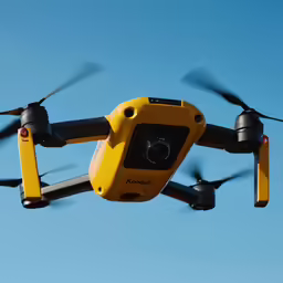 an overhead view of a yellow hover flying through the air