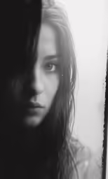 a woman is standing in front of the window