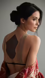 a woman with a brown and gold piece on her back