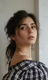 a girl in plaid shirt looking off into the distance