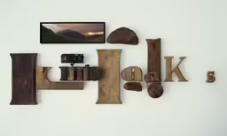 a white wall with wooden letters and pictures on the wall