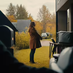 a woman is looking at her laptop in an outside view