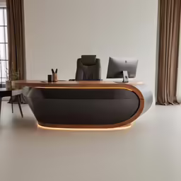 a well lit desk with computers and office equipment