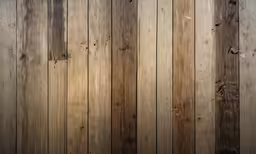 a wall with wood panels and peeling paint