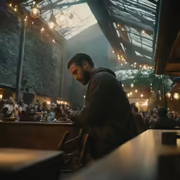 the man in the jacket is sitting in front of a bar