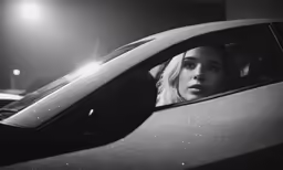 a lady sitting in the back seat of a car