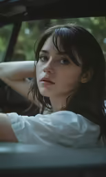 a woman sitting in the driver seat of a car