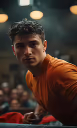 a young man is sitting on the edge of the stage