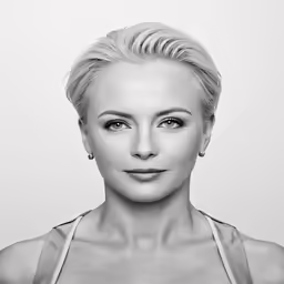 a woman in a tank top is posing for the camera