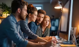 a group of people working at a computer