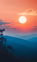 the sun is rising over mountains in the sky