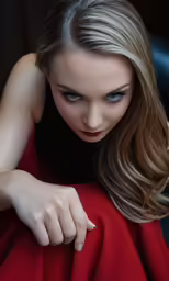 a woman wearing a red outfit sits on a blue couch