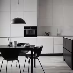 a kitchen with chairs, stove and sink