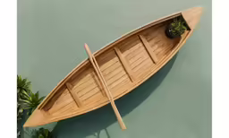 there is a long rowboat that sits in the water
