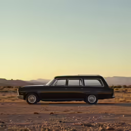 a black station wagon parked on the side of a road