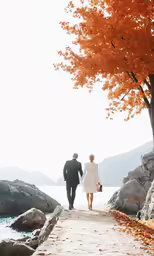 two people dressed in black are walking on the beach
