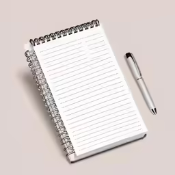 a white spiral notebook on a white surface