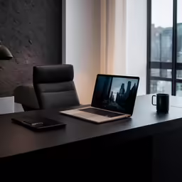 a large wooden table and chair near a windows