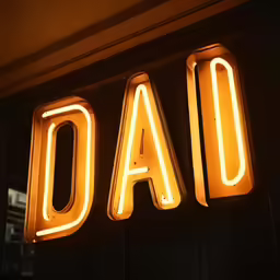 a neon sign saying dad and it appears to be in neon yellow