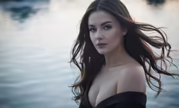 a beautiful woman is wearing a strapless top by the water