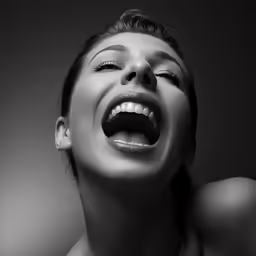 a beautiful woman smiling while looking in the mirror