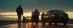 people walking to their vehicle while the sun is rising
