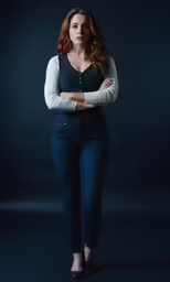 the attractive, young woman in jeans is posing