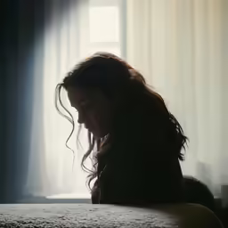 a woman looking down at her cell phone