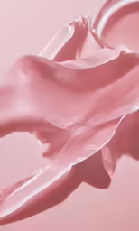 a pair of scissors on a pink surface