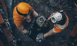 two workers are seen from above on a job site