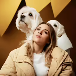 a woman and a white dog in front of a star background