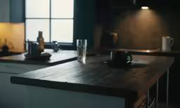 a coffee mug sits on a wooden table next to a window