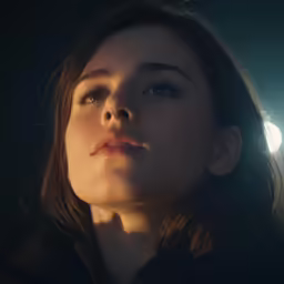 a woman that is staring away with the light on