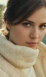 a woman looking away with a scarf on