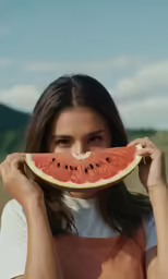 woman with a slice of watermelon over her face