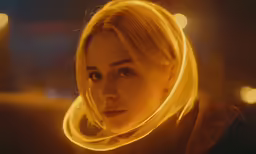 the blonde woman is looking back while wearing a scarf