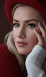 a close up of a person wearing a red hat
