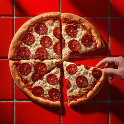 two slices of pepperoni pizza on a red table