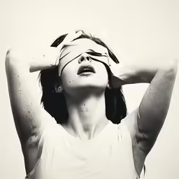 a woman looking up to her blind in the air
