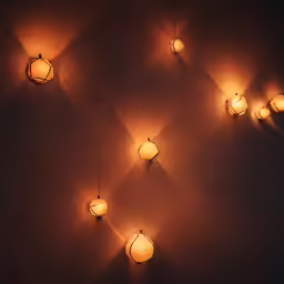 a wall with five lamps that are lit up