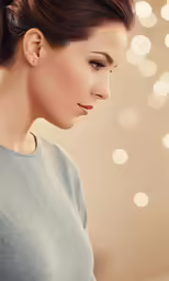 an attractive woman with blue eyes looking down at something