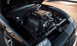a black vehicle with the hood open with a v8 block on