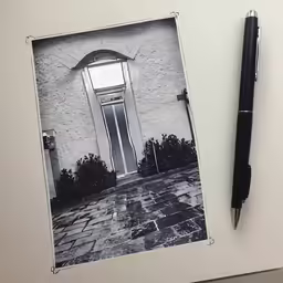 a pen is next to a photo and pen
