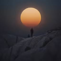 a man standing at the edge of a cliff with a dog