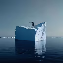there is a person on top of a large iceberg